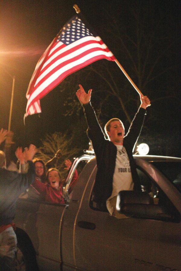 A students shouts out of a truck window to celebrate with community members walking past the Memorial Union to Central Campus on Sunday night.