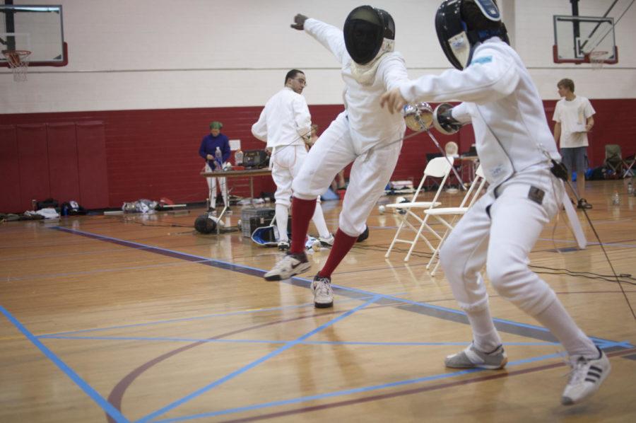 Rene Hamilton, right, senior in aerospace engineering, attempts
to score a point while his opponent blocks him during the Iowa
Games fencing competition on July 16 in Beyer Hall. 
