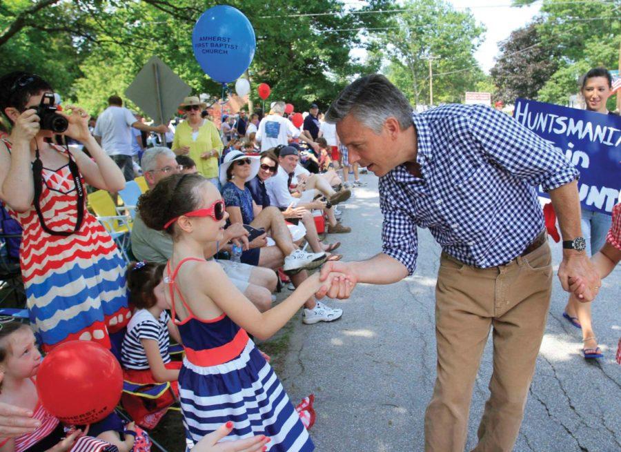 Republican presidential candidate and former Utah Gov. Jon
Huntsman Jr., shakes hands with Molly Graybill as he marches in the
Fourth of July parade in Amherst, N.H. on July 4. 
