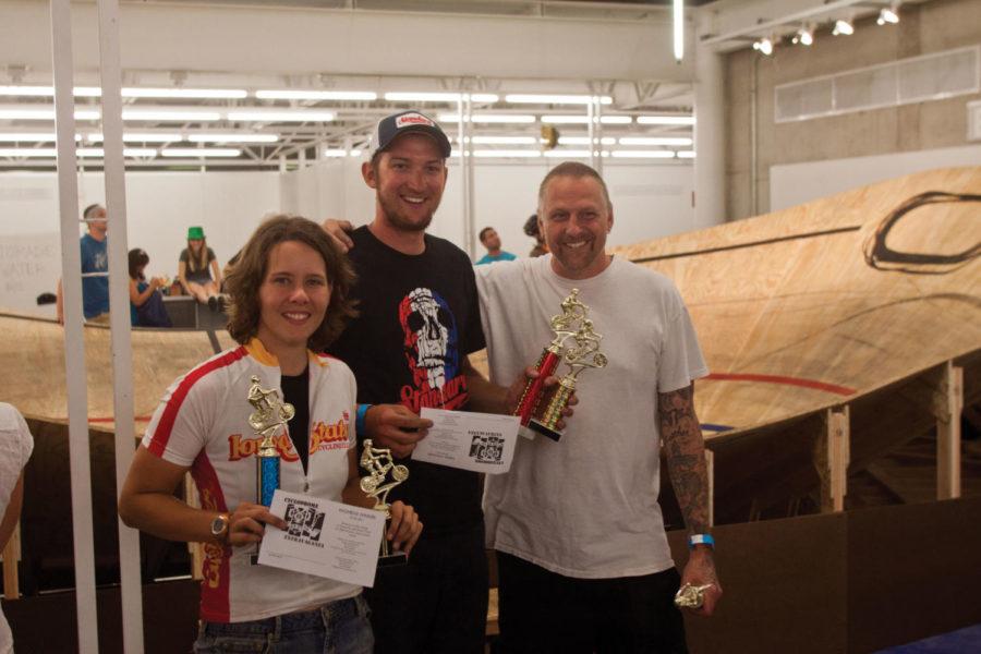 Event winners Kim Topp and Adam Prosise pose with Dan Koenig of
Yankee Doodle Tattoo on July 7 in the College of Designs King
Pavilion. 
 
