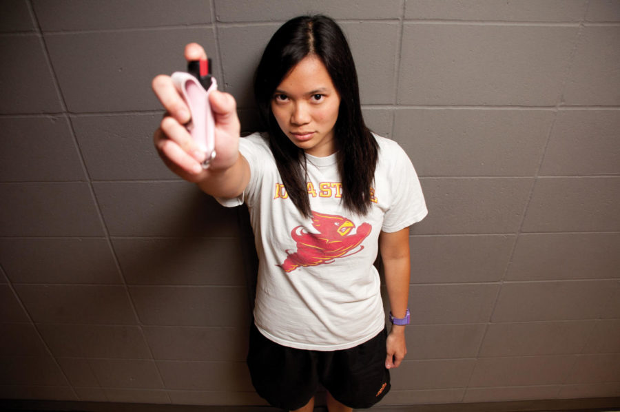 Tania Lee Xu Yar, junior in nutritional science, poses with a
container of pepper spray that she got after she was attacked June
29, 2011. 
