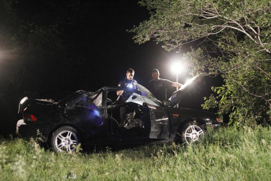 Ames police officers examine a car involved in a single-car
accident Wednesday night on Mortensen Parkway between Beach and Ash
avenues. The car was headed eastbound on Mortensen Parkway when it
lost control around 10:15 p.m. Two people were in the car and were
taken by helicopter to Des Moines.
