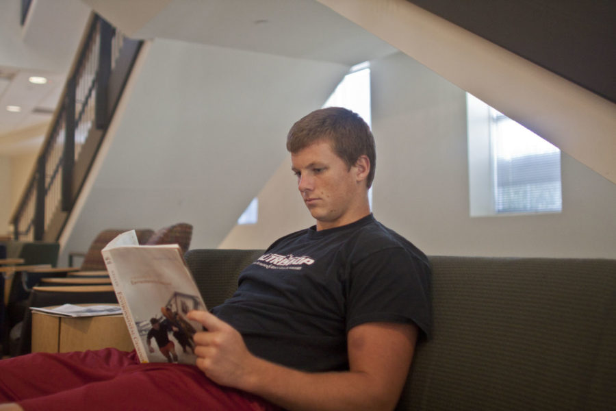 Pierce Richardson, sophomore in criminal justice studies, reads
in Hixson-Lied Student Success Center. Richardson plays tight end
for the football team.

