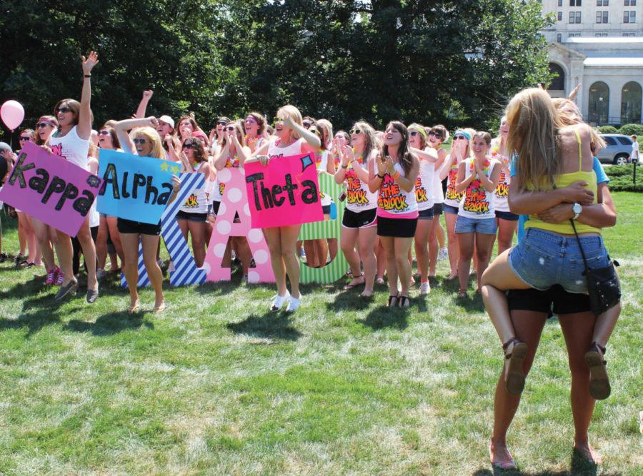 Members of Kappa Alpha Theta sorority cheer for their new
sisters while two members of Gamma Phi Beta sorority celebrate with
a hug during Bid Day festivities on central campus on Aug. 18. 
