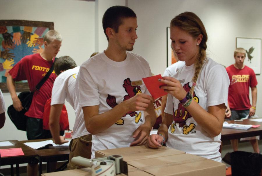 Zac Illg, sophomore in kinesiology and health, hands off a
student's reservation information on Aug. 18 to Lauren Meyer,
sophomore in dietetics, so that she can run and find a student's
box of books. Illg and Meyer were both hired as temporary employees
by the University Book Store to aid with the rush of textbook
reservations before fall semester.
