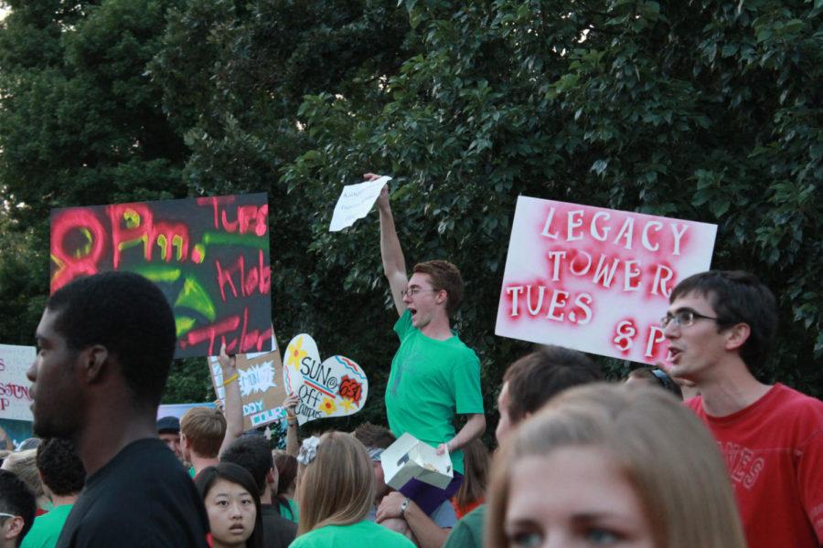 Nathan Kaloupek, junior in linguistics, and other connection
group leaders hold up signs to help gather and guide new and
returning students into organized groups on Thursday. Connection
groups are organized by where the student lives. 
