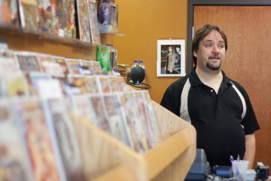 Chris Pellack, owner of Old Curmudgeon talks comic books with
customers on Aug. 20 in his store.
