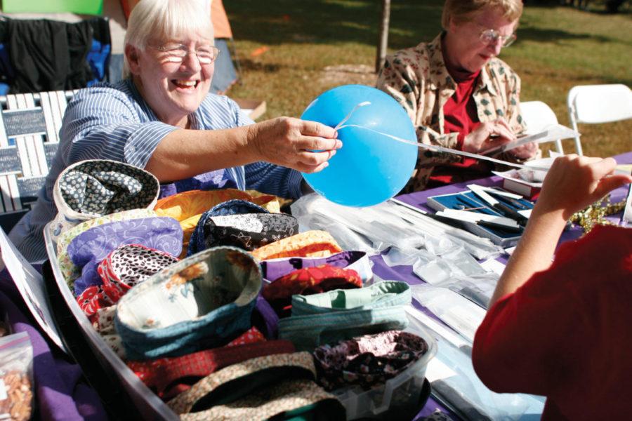 Janet Gray, of Ames, helps untie a knot of a balloon during the
FACES of Ames 2011 event at Bandshell Park, Saturday, Sept. 24.
Gray represented the Ames chapter of the Tri-T Society which was
selling snippet bags, Rada cutlery, nuts and gift card holders.
 
