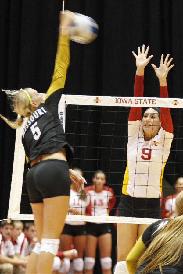 Setter Alison Landwehr jumps up to block a spike from Missouri
outside hitter Lisa Henning during Wednesday nights game at Hilton
Coliseum. Landwehr had three kills and nine points to aid in a 3-0
Cyclone victory over the Tigers.
