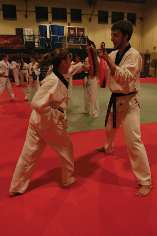 Taekwondo members Christina Holaday, junior in performing arts,
and Mark Stenerson, graduate in genetics development and cell
biology, practice at the Forker Building on Monday. Club meets
three times per week to practice and learn self-defense. 

