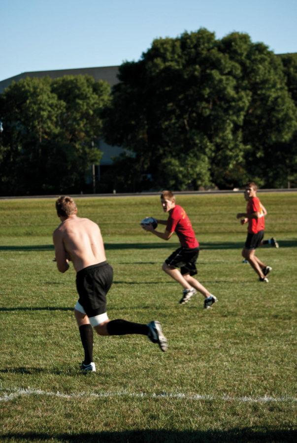 The rugby team works on its passing Tuesday night at
practice.
