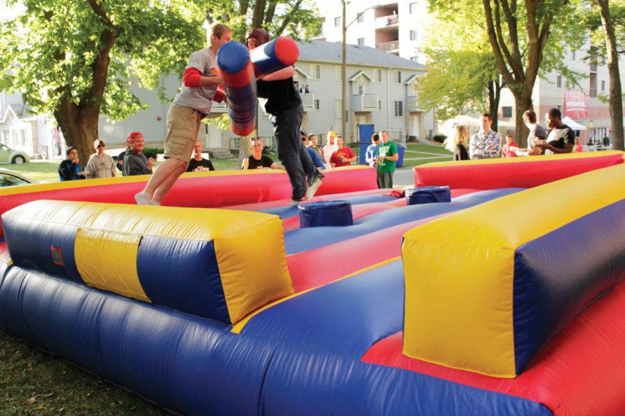 Ben Smith, senior in civil engineering, battles Aaron Bauer,
senior in journalism and mass communication, in bounce jousting at
Campustown Property Managements 9/24 block party along Stanton
Avenue on Saturday, Sept. 24. In addition to the companys
announcement of The Resort, highlights included free food,
sunglasses and a raffle with prizes ranging from Jeffs Pizza to
Visa gift cards. 
