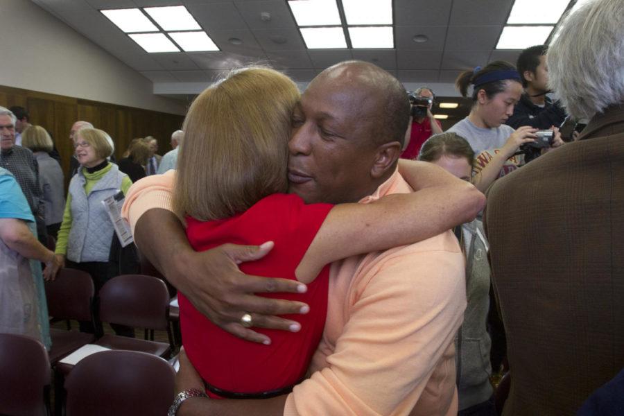 ISU Alumni Association President and CEO Jeffery Johnson hugs
Janet Leath during the ceremony of Steven Leaths announcement as
Iowa States next president. 
