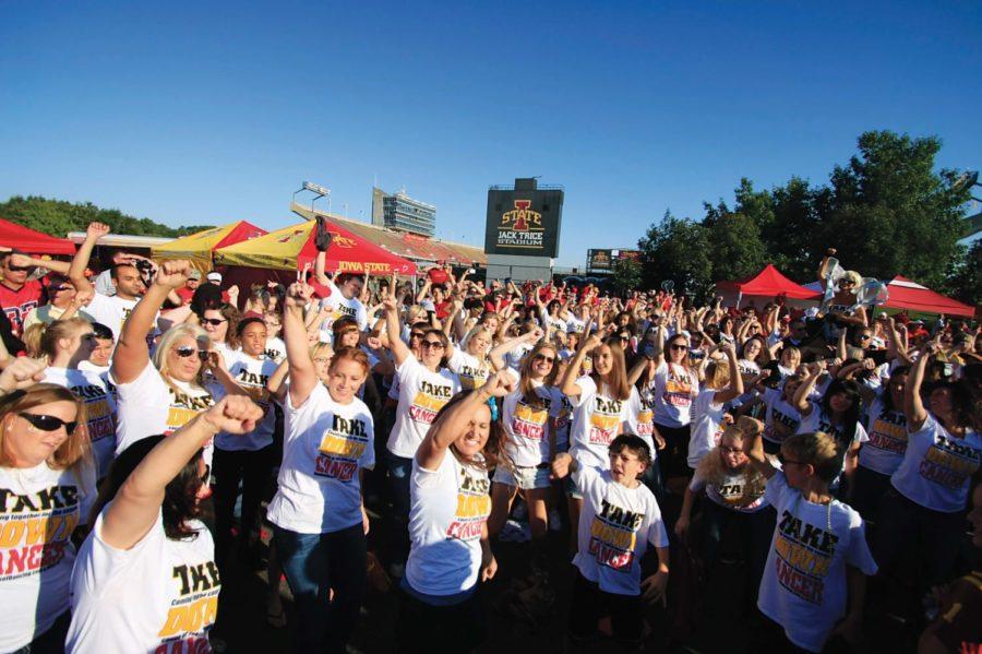 
Participants in the Take Down Cancer flash
mob, which took place on Saturday just south of Jack Trice Stadium,
dance to Party Rock Anthem by LMFAO to help show their support
for fighting cancer. The event was held to help raise money for the
National Foundation for Cancer Research.

