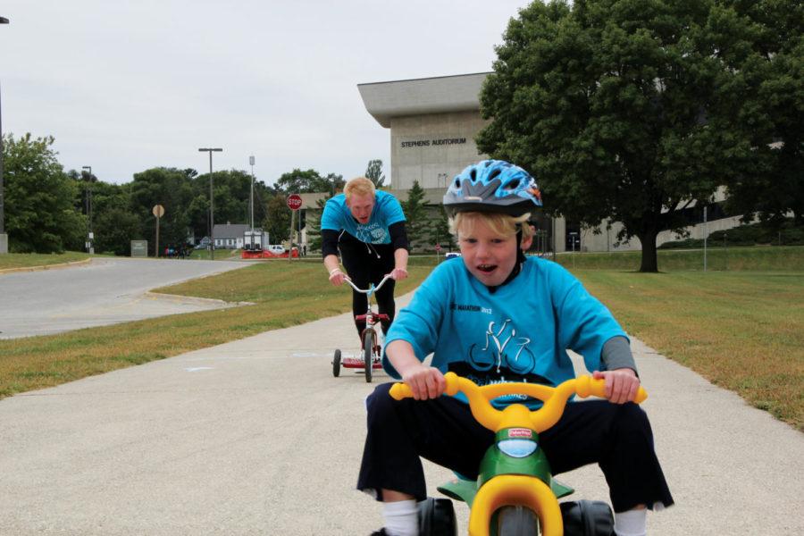 Ben Hammes defeats Blake Bruene, junior in biochemistry, at the
tricycle race during the ISU Dance Marathon annual bicycle race
event Teal Wheels Saturday, Sept. 17. ISU Dance Marathon gathers
emotional and financial support for children with life threatening
illnesses and their families. 

