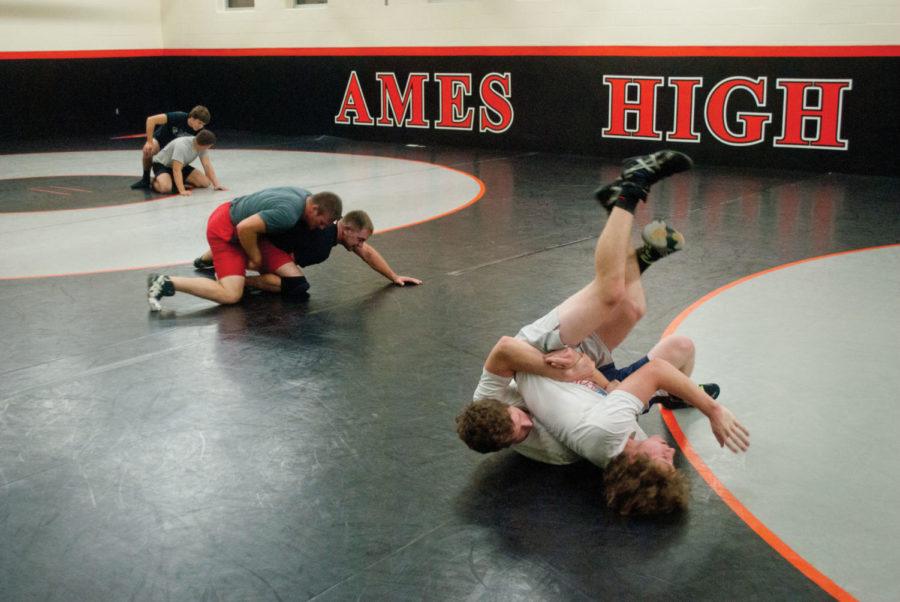 The+club+wrestling+team+warms+up+at+Ames+High+on+Oct.+10+for%0Atheir+first+year+of+real+competition.+The+team+practices+four+days%0Aa+week+at+the+Ames+High+School+wrestling+room.%0A