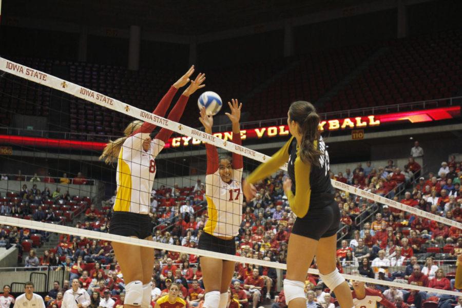 Rightside hitters Kelsey Petersen (left) and Tenisha Matlock
jump up to block a spike from a Missouri opponent during Wednesday
nights game at Hilton Coliseum Sept. 21, 2011. Petersens 11.5
points and Matlocks nine points contributed to a 3-0 Cyclones
victory over the Tigers. 
