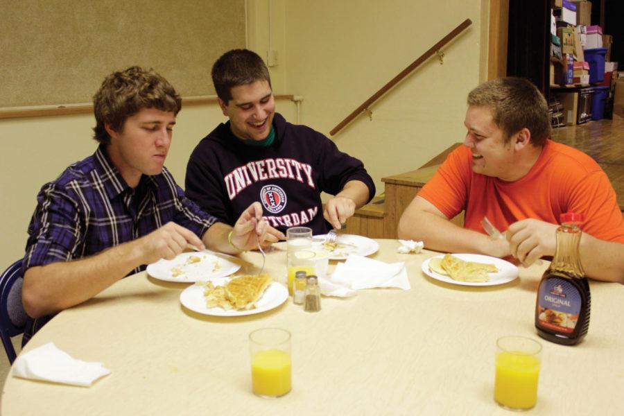 Ryan Hanrahan, senior in finance, Jens Pedersen, senior in
mechanical engineering, and David Sappenfield, senior in
mathematics, share a laugh at the Wesley Foundation Student
Center's free midnight breakfast in the early hours of Saturday,
Oct. 1, at Collegiate United Methodist Church. The Foundation hosts
the event, which offered pancakes, waffles and made-to-order
omelets, each month. The next midnight breakfast will be held at
11:30 p.m. on Oct. 28.
