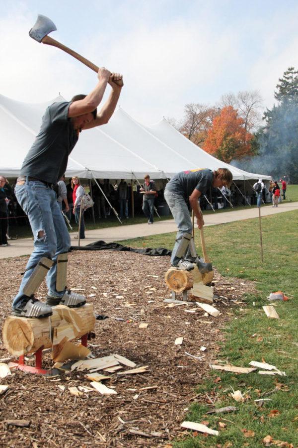 Ryan Rieger, junior in forestry, and Jarett Cook, second-year
graduate student in forestry and sustainable agriculture, compete
in the Forestry Club demonstration on Central Campus on Tuesday,
Oct. 20. The Forestry Club offers forestry-related events for
students to be involved in, including Timbersports. Rieger and Cook
make up the team "Holy Rollers," which competes in Timbersports,
like chopping the logs in half the fastest. 
