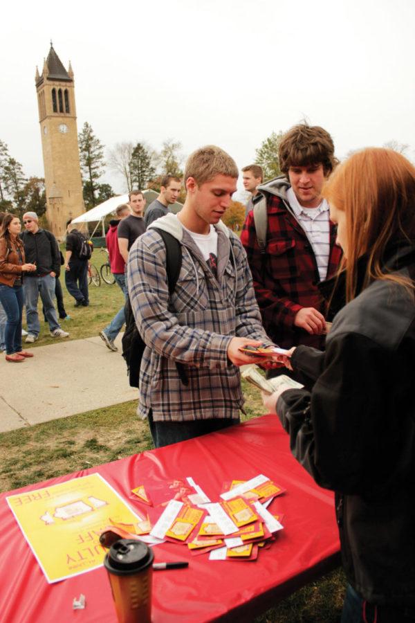 Kevin Turner, junior in aerospace engineering, and Tyler Lage,
senior in civil engineering, purchase Homecoming buttons from Sarah
Patras, treasurer of the Homecoming Central Committee, on Central
Campus on Monday, Oct. 17. The buttons, which are redeemable for
five meals over the course of Homecoming Week, will be available at
the food tent on Central Campus for $5. 
