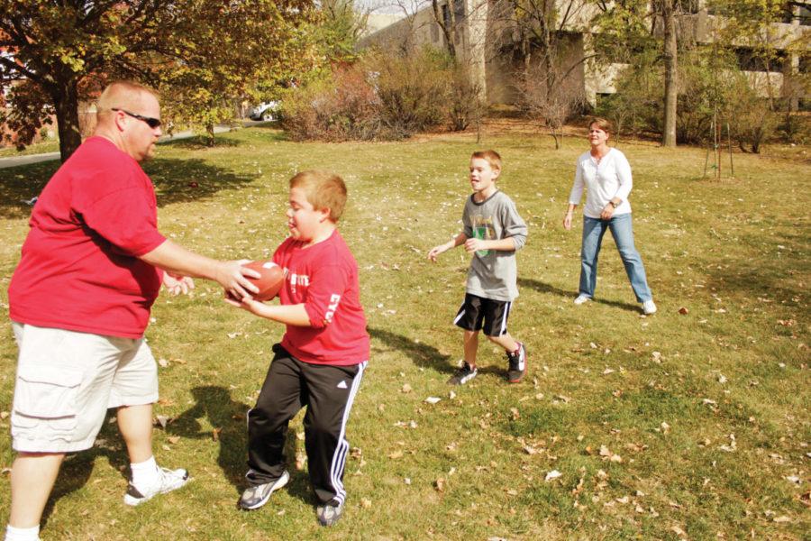 Steve and Amy Koffron play a pickup game of football outside of
the Enrollment Services Center with their sons Ryan and Nicholas on
Sunday, Oct. 23. Steve and Amy are ISU alumni who now reside in
Cedar Rapids, Iowa, yet try to return to campus each year for
Homecoming. Ryan and Nicholas both aspire to play football for the
Cyclones someday.
