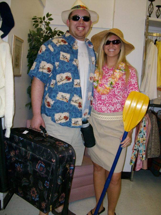 Students pose as a tourist couple in costumes from Goodwill.
