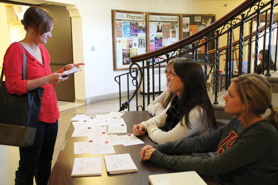 Mackenzie Akers, sophomore in event management, and Ericka
Green, sophomore in child, adult and family services, talk with
Bethany Schafer, senior in marketing, about their handouts for the
Delta Delta Delta sororitys End Fat Talk campaign. The Tri Delt
house proposed a challenge to promote positive self-image by
getting rid of negative comments around campus.  

