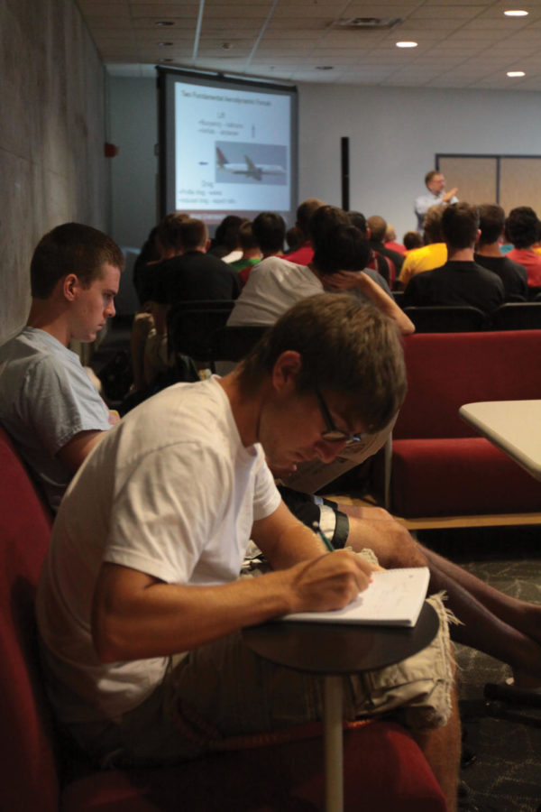 Matt Upah, freshman in aerospace engineering, takes notes during
class AerE 160 on Monday. This course takes place in the Howe Hall
atrium. 
