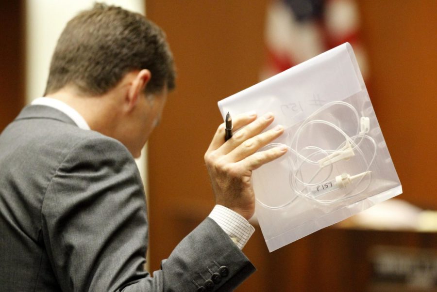Deputy district attorney David Walgren holds an intravenous line
found at Michael Jacksons residence during Conrad Murrays trial
in Los Angeles on Oct. 6, 2011.
