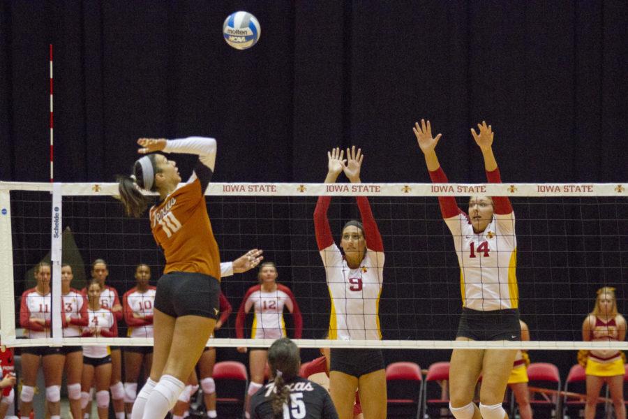 Texas outside hitter Haley Eckerman prepares to spike the ball
over Iowa State’s Allison Landwehr and Jamie Straube during the
game on Sunday. Eckerman, a Waterloo native, had 21 kills during
the game, and the Cyclones lost with a final score of 2-3.
