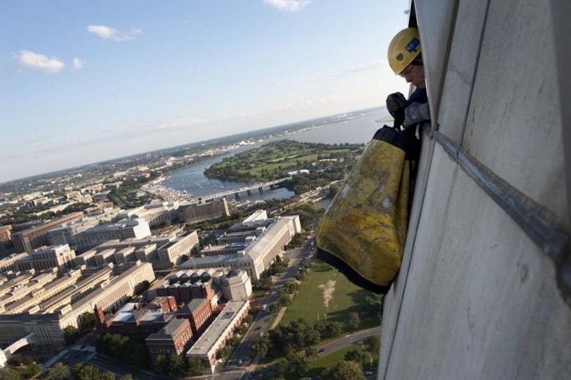 Dave Megerle pulls in a debris bag. Contractors
from Wiss, Janney, Elstner Associates conducting
exterior assessment of the Washington Monument Sept. 30,
2011
