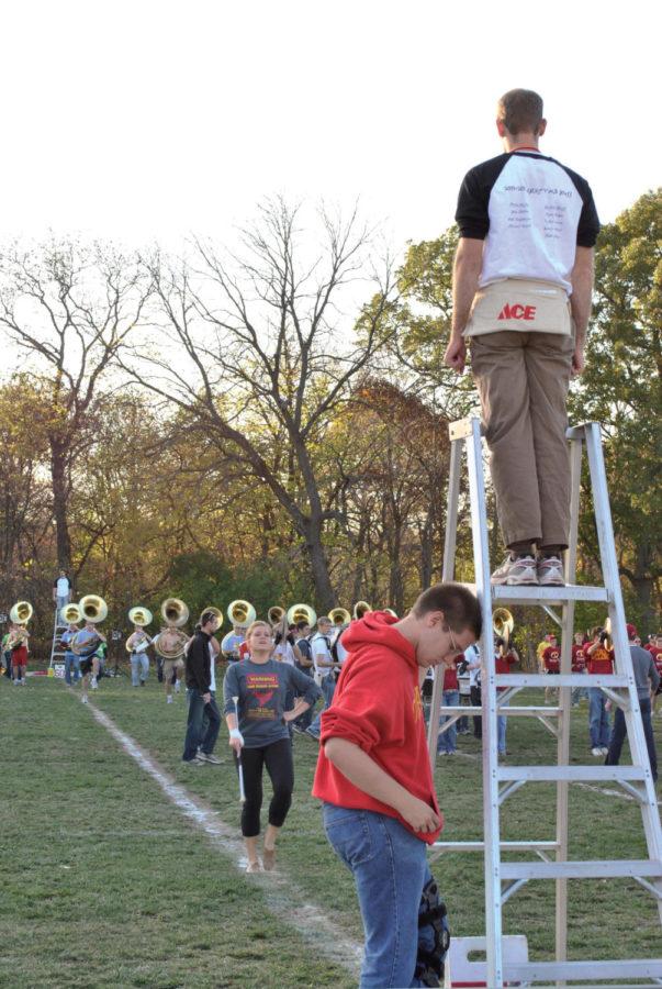 The ISU Cyclone Football Varsity Marching Band practices its
halftime show as alumni band members look on Friday, Oct. 21, at
the band practice field. Drum majors help to organize the different
sections of the band.
