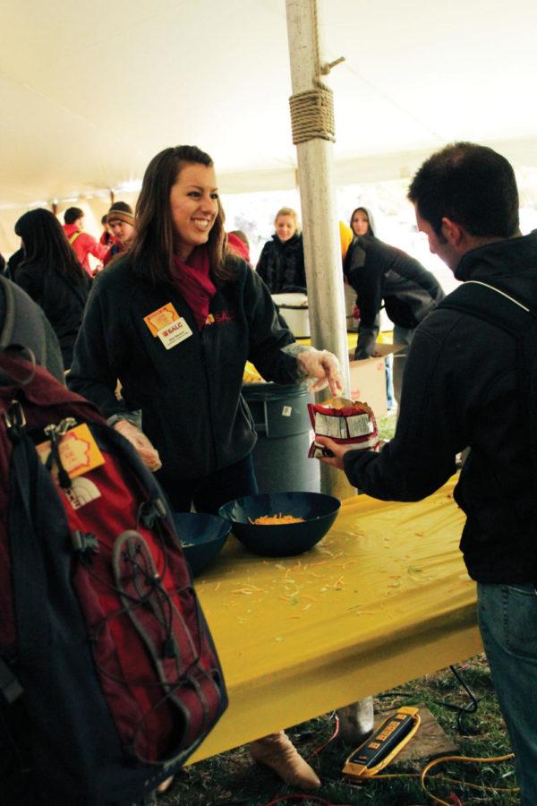 Alex Menard, senior in anthropology and co-director of managing
and marketing for the SALC Executive Committee, serves walking
tacos inside the Homecoming Food on Campus tent on Central Campus
on Wednesday, Oct. 19. The week long event is staffed by members of
various SALC committees, among them the Executive Committee and the
Homecoming Central Committee. 
