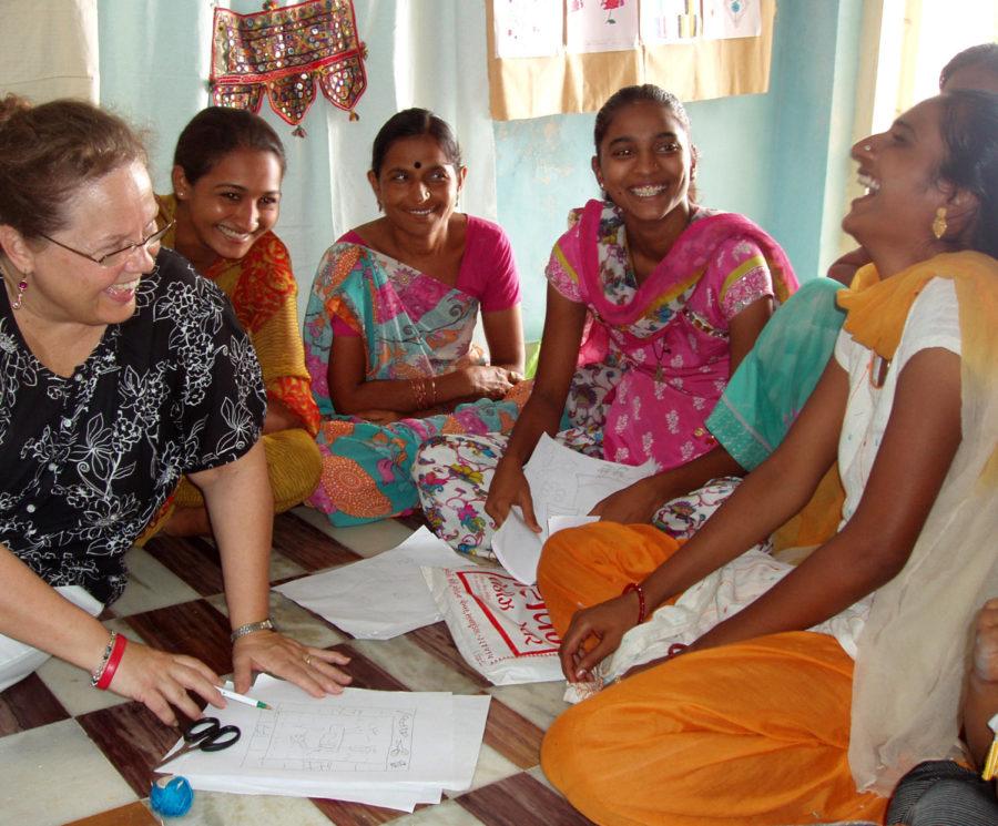 
Cindy Gould, ISU Associate Professor, shares a laugh with
Kailashben and other students participating in an embroidery
training program in Savarkundla, Gujarat, India.

