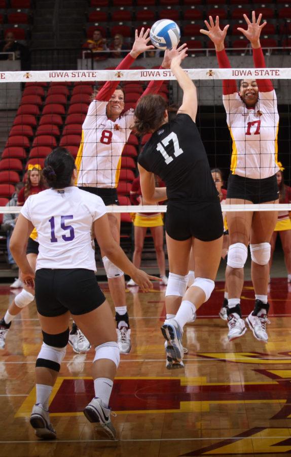 Right side hitter Kelsey Petersen and outside hitter Victoria
Hurtt attempt to make a block on Wednesday, Nov. 16 at Hilton
Coliseum.
