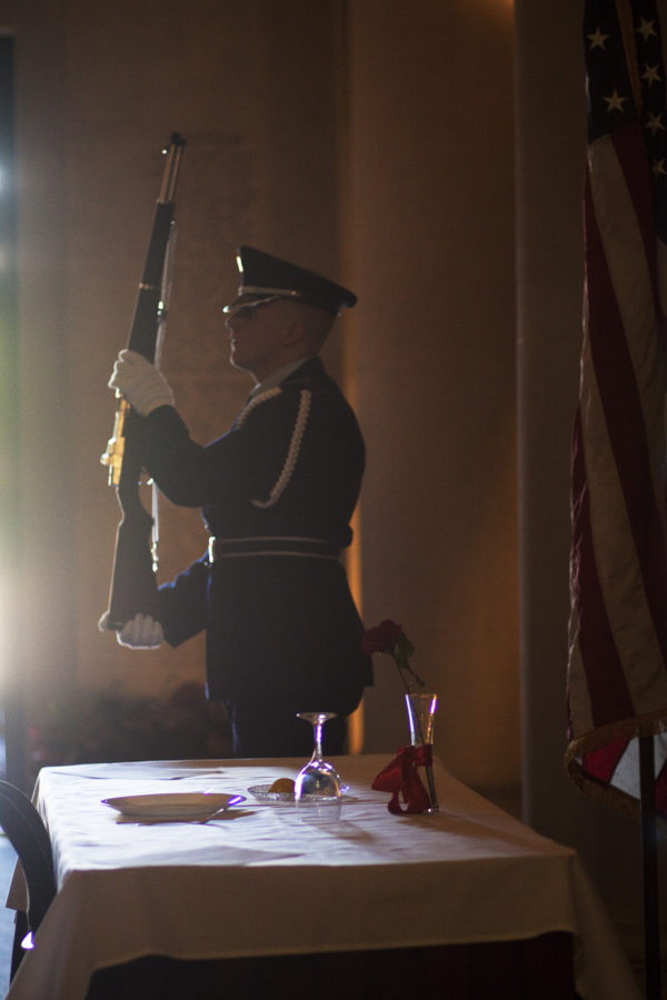 Air Force ROTC honor guard member, Cody Beemer, sophomore in civil engineering, stands at attention next to a display for national POW/MIA recognition day Friday, Sept. 17 in the Gold Star Hall in the Memorial Union. The empty table is set to recognize prisoners of war and those missing in action.
