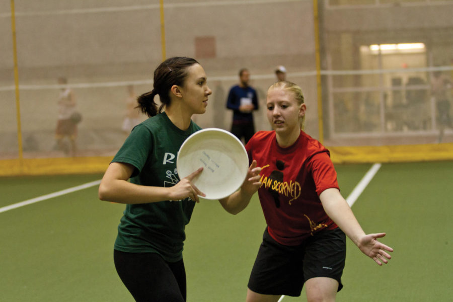 Britt Schenk, right, senior in interior design, guards her
teammate during a drill. The Iowa State Ultimate Club team
practiced at Lied Recreation Athletic Center on Tuesday, Nov.
8.

