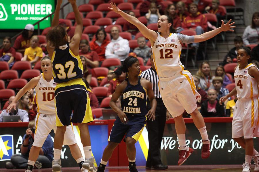 Junior guard, Jessica Schroll closes in on Northern Arizona
guard Amy Patton. The Cyclones beat the Lumberjacks 65-41, giving
them a 4-0 record.
