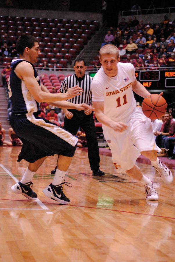 ISU guard Scott Christopherson drives the ball past a Northern
Colorado defender during the first half of Iowa States game
against the Bears on Tuesday, Nov. 22, at Hilton Coliseum. The
Cyclones broke a team record by hitting 16 3-pointers in the 90-82
win, including three from Christopherson, who scored 11 points.
