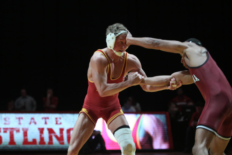 Luke Goettl tries to counter the attack of Oklahomas Kendrick
Maple during the dual meet on Sunday. Maple won the match 13-5 on a
major decision. The Cyclones lost to the Sooners 22-13.Photo: David
Merrill/Iowa State Daily
