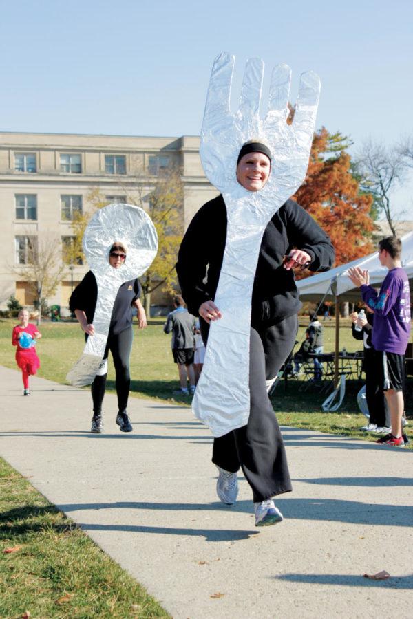 Chris Burg and Jen Fine, both of Johnston, Iowa, approach the
finish line of the Youth Shelter and Services Pair Up 4 a
Purpose 4k run on Central Campus on Sunday, Nov. 6. Runners were
invited to dress up as famous pairs for the race, which benefited
YSSs GRIP mentoring program. 
