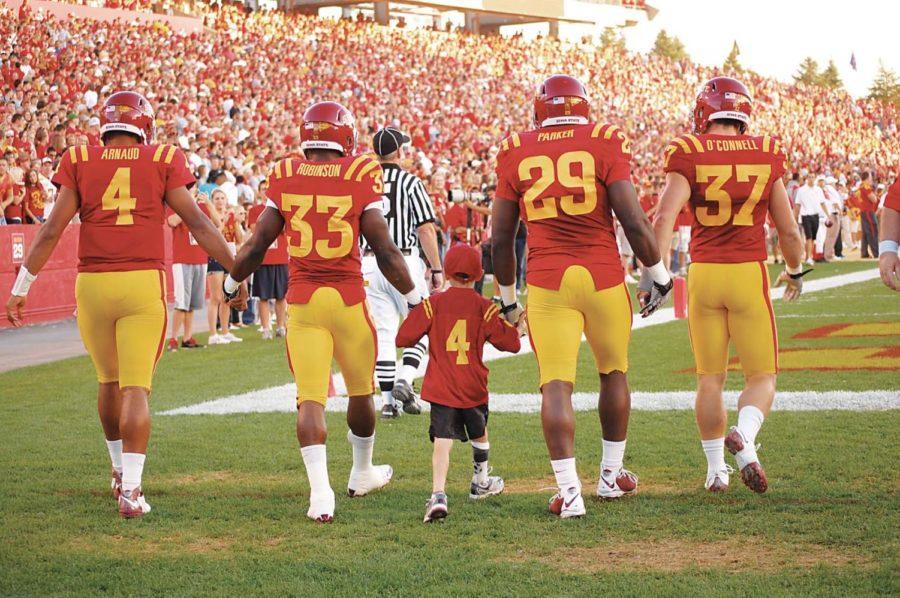 James Pollard walks on the field with the football team before
the Oct. 9, 2010, game against Utah as an honorary captain. 
