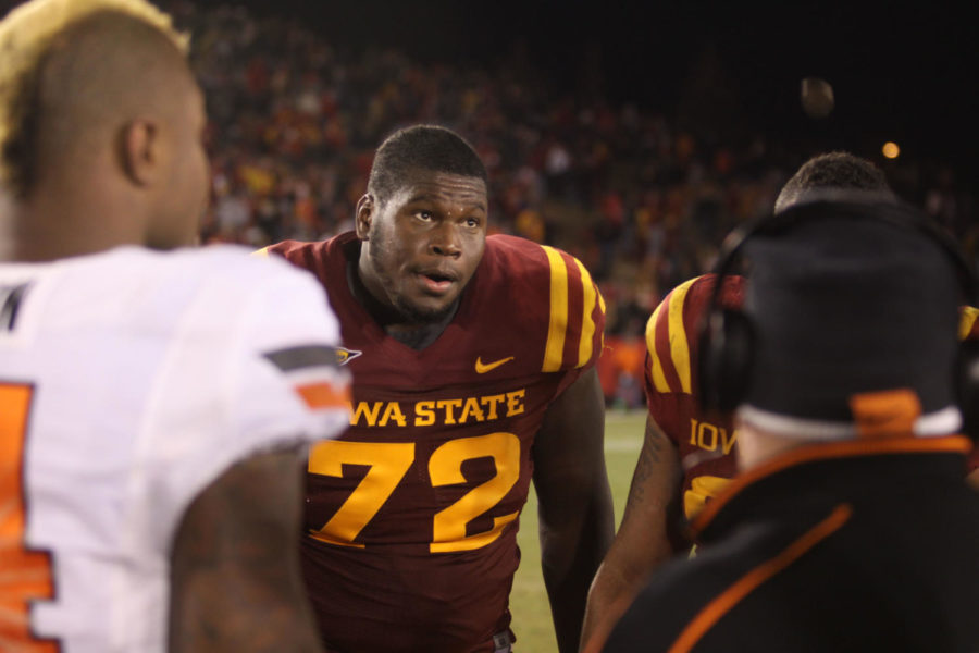 
 Kelechi Osemele watches as the overtime coin toss comenses at
midfield. Iowa State would go on to score on the opening play of
overtime, putting pressure on Oklahoma State.
