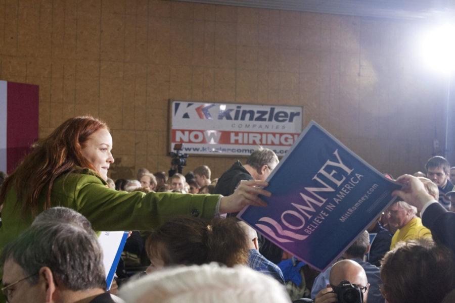 Mitt Romney rally signs are handed out to a crowd of several
hundered on Thursday, Dec. 29 at Kinzler Construction in Ames. The
rally signs were a popular item to have signed by the hopeful
presidential candidate.
