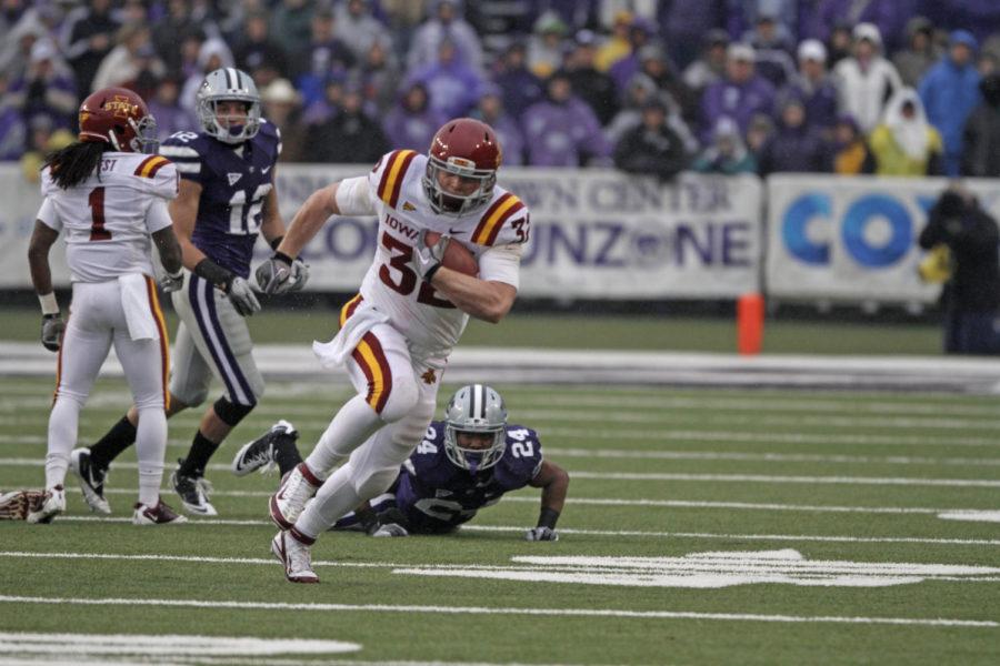 ISU running back Jeff Woody breaks a tackle during the first quarter of Iowa State's 30-23 loss to No. 11 Kansas State on Saturday in Manhattan, Kan. Woody tallied career highs in carries (24), rushing yards (86) and touchdowns (two) for the Cyclones in the loss.