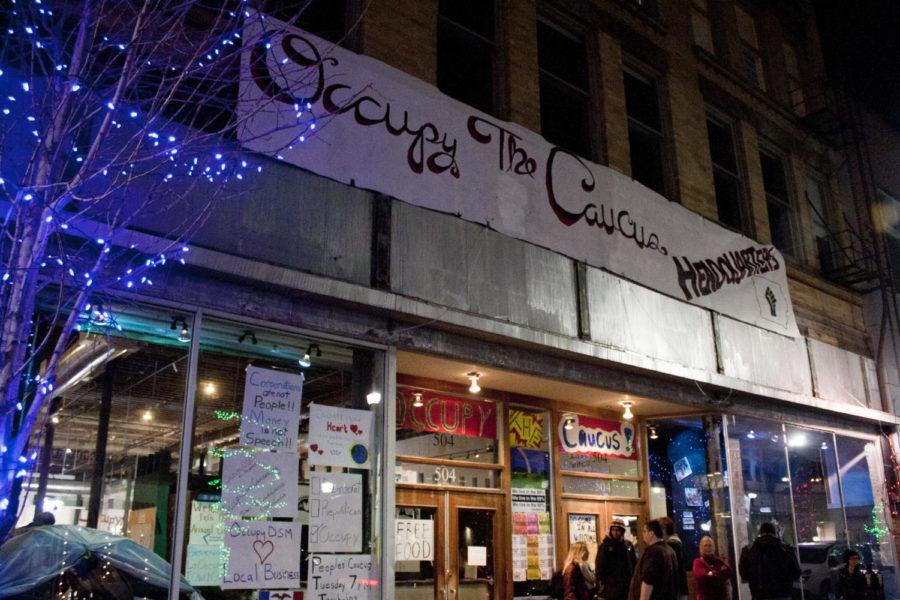 A group of people stand outside of the Occupy the Caucus
headquarters in Des Moiness East Village on Tuesday, Dec. 27
before the Peoples Caucus, the first planning meeting of the
Occupy the Caucus movment. 
