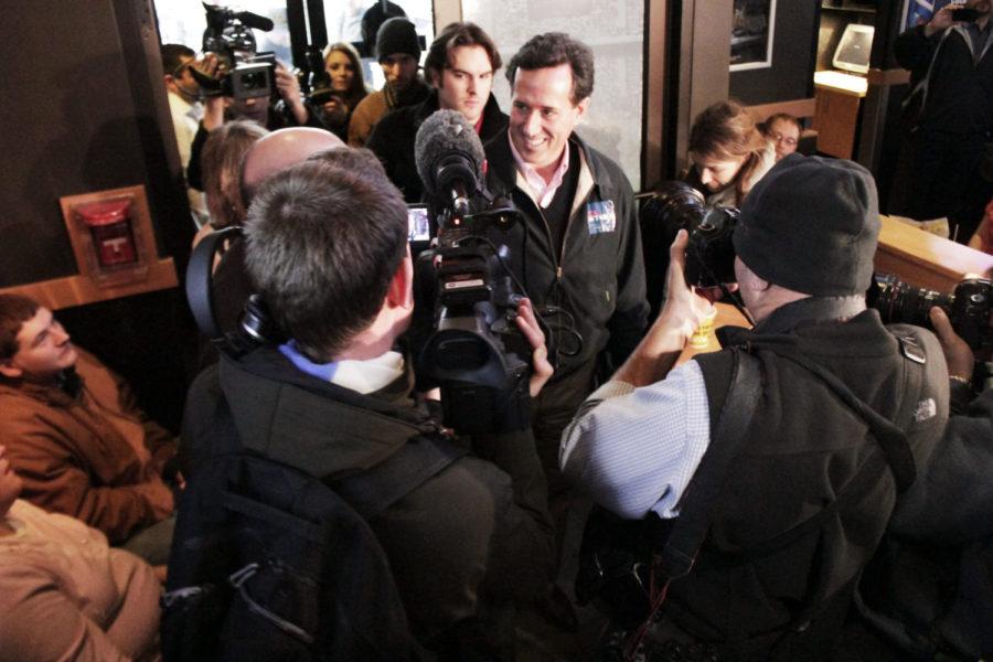 Rick Santorum, former republican congressman from Pennsylvania,
is met with questions from the press as he walks into Buffalo Wild
Wings in Ames on Friday, Dec. 30. Santorums stop, which consisted
of a Pinstripe Bowl game-watching party, was one of four campaign
stops around Iowa on Friday, leading up to the 2012 Iowa caucuses,
which will take place on Jan. 3rd. 
