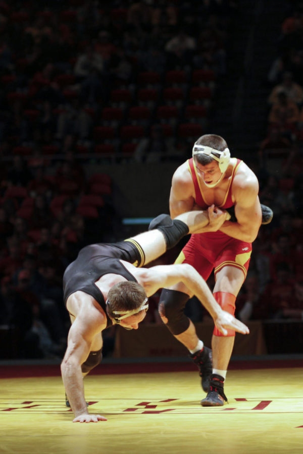 Boaz Beard, wrestling at 184, fights to keep his Iowa opponent,
Vinnie Wagner, from escaping during Iowa-Iowa State meet held
Sunday afternoon at Hilton Coliseum. Beard defeated Wagner 10-9,
but the Cyclones fell to the Hawkeyes 9-27.
