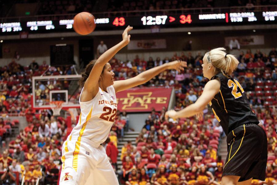 Iowa State guard reaches to block a pass by an Iowa forward. The
Iowa State Womens basketball team defeated Iowa, Wednesday, Dec.
7, with a final score of 52-46. 
