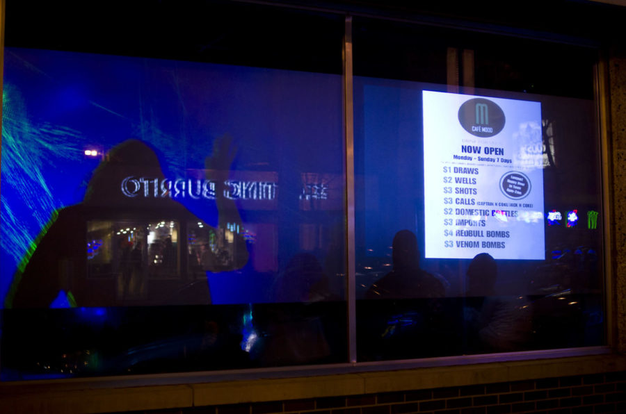Frosted glass windows and a system of projectors display drink
specials in a unique way to people outside of Cafe Mood in hopes of
drawing in more customers. Once the complete system of projectors
is in place, the owners hope to utilize the window displays for
game nights.
